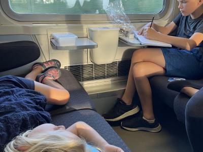 Writing in the travel journal and catching a nap between cities.